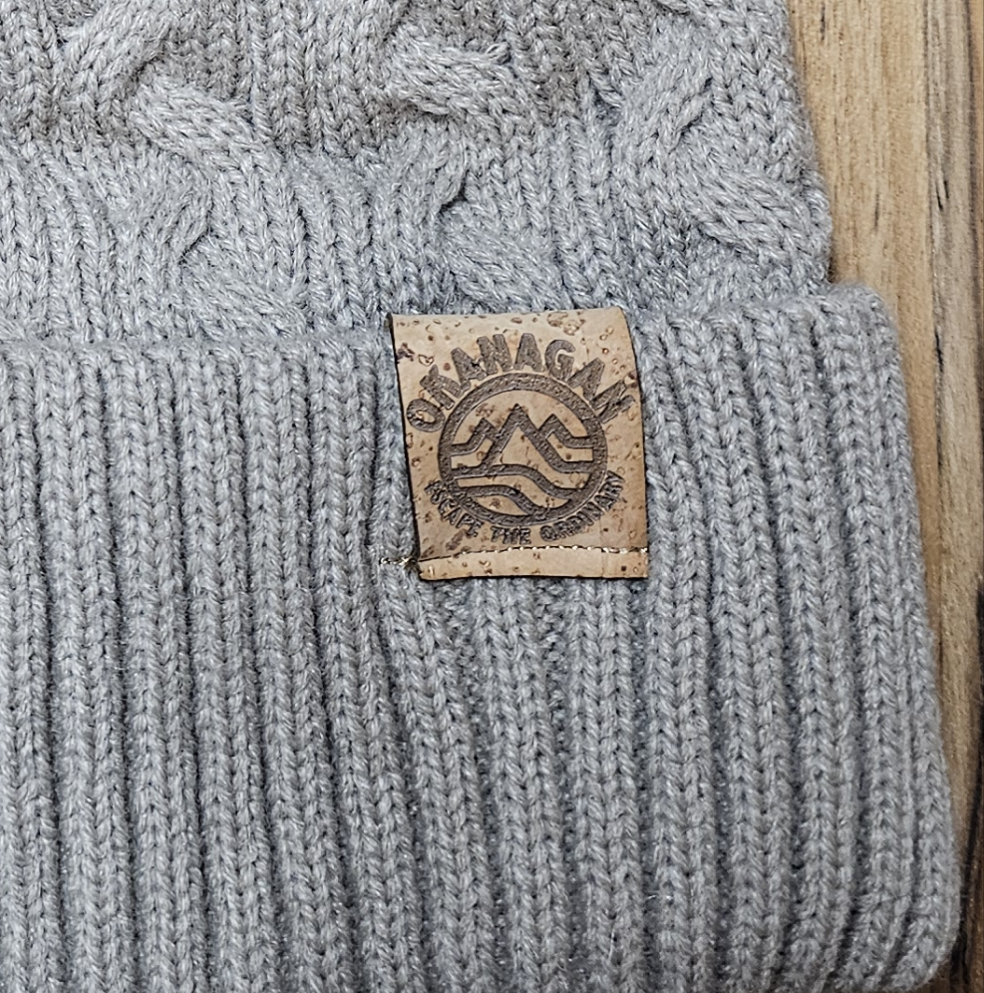 Okanagan Wave Cable Knit Toque in Oatmeal with Faux Fur Pom and Cork Patch